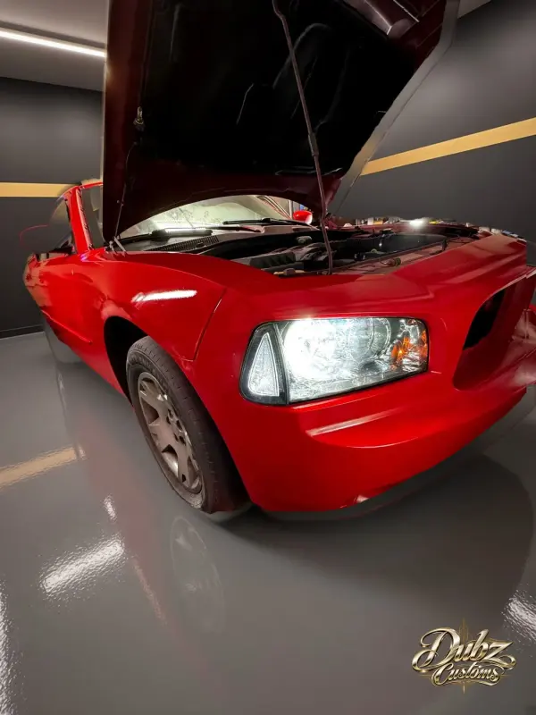 Red Dodge Charger with a bright refinished front end