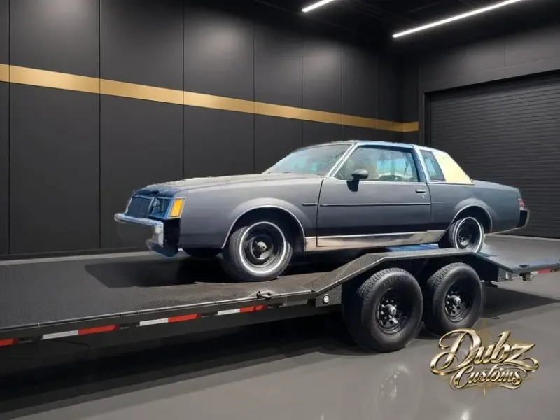 Gray Buick Regal arriving on a trailer