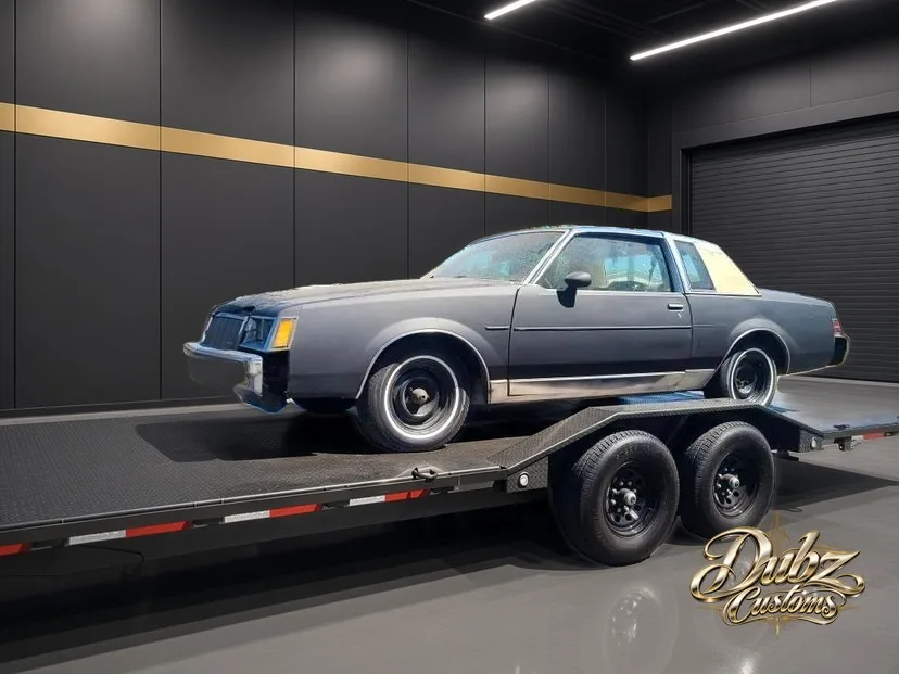 Gray Buick Regal arriving on a trailer